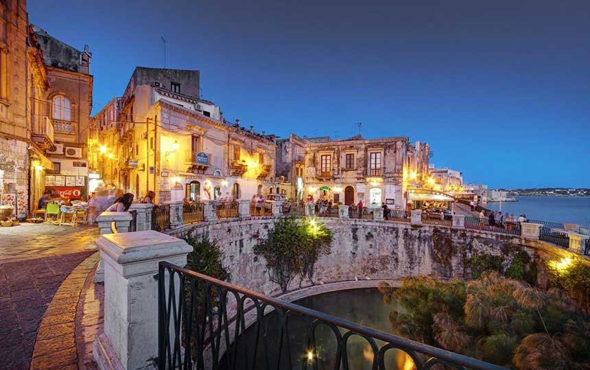 Fonte Aretusa illuminata di sera a Ortigia